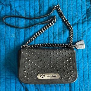 Coach: black pebble textured leather w/ gunmetal hardware. Shoulder or crossbody